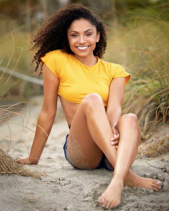 Kierra Sari smiling in a yellow shirt