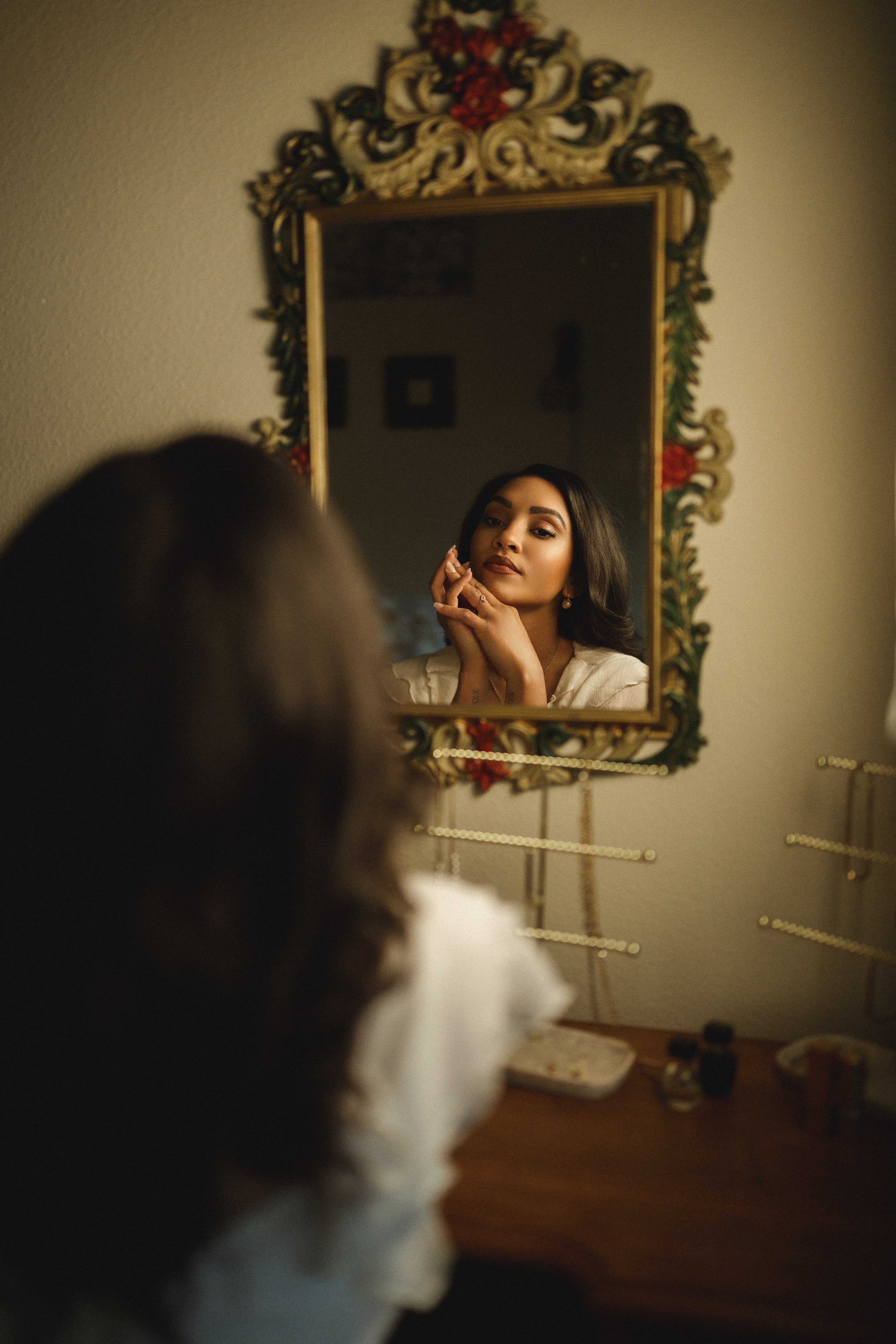 Kierra Sari reflected in an ornate vintage mirror